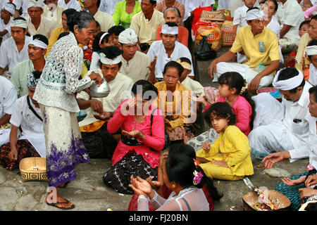 Hindu Balinese people praying during Kuningan ceremony in Ubud, Bali , Indonesia Stock Photo