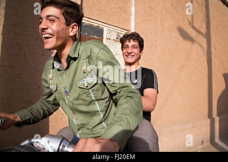 Iranian young  men have fun on motorbike in the streets of Kashan Stock Photo