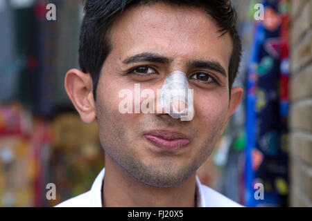 Portrait of Iranian man with bandage because of recent nose plastic surgery, Iran Stock Photo