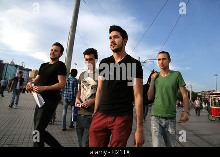 Young men walking on Taksim square , Istanbul Stock Photo