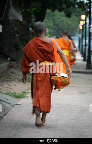 Buddhist monk walking in the streets of in Luang Prabang , Laos, Asia Stock Photo