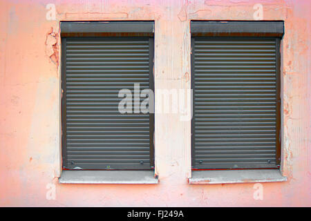 Two windows covered with blinds Stock Photo