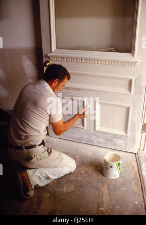 Professional painter painting door in historical house, Charleston, South Carolina, USA Stock Photo