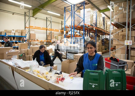 Factory workers pack boxes of First Aid kits in Hendon, England Stock Photo