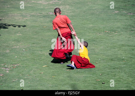 Buddhist monks are playing in monastery gompa in Boudhanath, Nepal Stock Photo