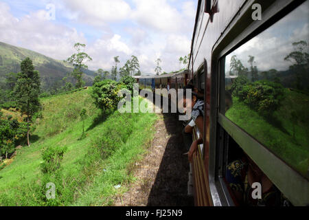 On the road on a train in green Sri Lanka in the middle of the island Stock Photo