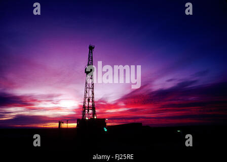 Oil rig at sunset; New Mexico, USA Stock Photo