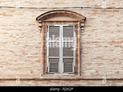 Old window shutters in ancient stone wall, background photo texture Stock Photo