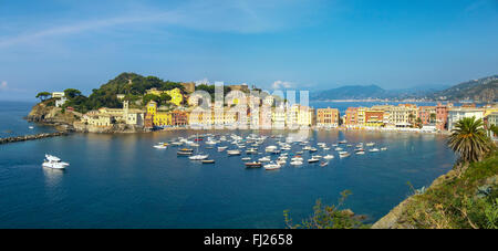 Panorama of Baia del Silenzio, the peninsula, and the small boat harbor of the town of Sestri Levante, Liguria, Italy. Stock Photo