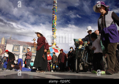 Tibetan people praying / doing Kora around Jokhang temple in Lhasa, Tibet Stock Photo