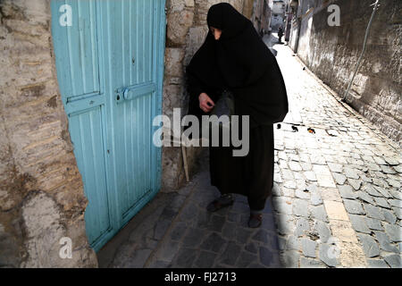 Old woman wearing niqab  in the streets of Sanliurfa Turkey Stock Photo