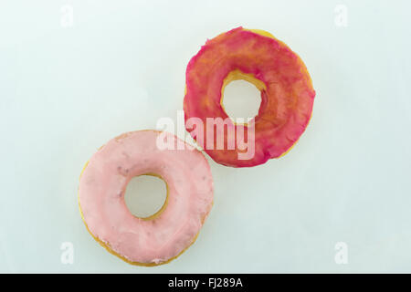 Two pink donuts with separate clipping paths, isolated on white background Stock Photo