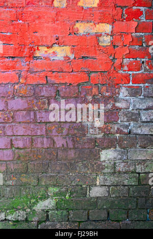 Weathered brick wall painted in three different colors Stock Photo