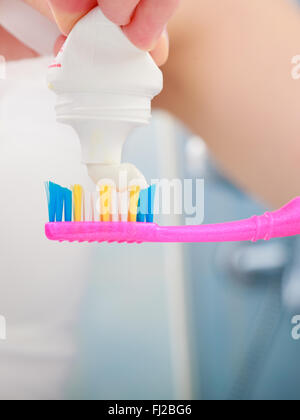 Female hand holding toothbrush with toothpaste isolated on white ...