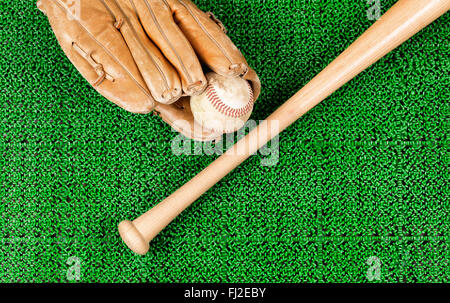 Overhead view of baseball mitt, ball and bat on artificial grass Stock Photo