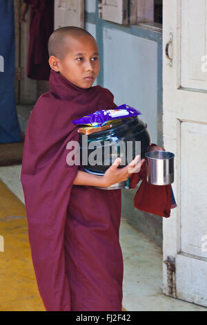 BUDDHIST MONKS are fed each day at 11 AM at the MAHAGANDAYON MONASTERY - MANDALAY, MYANMAR Stock Photo