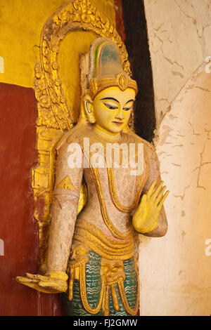 A Buddhist deity at ANANDA PAYA or TEMPLE which was built by King Kyanzittha around 1100 - BAGAN, MYANMAR Stock Photo