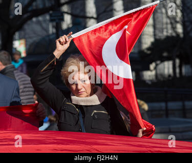New York, United States. 28th Feb, 2016. A demonstrator holds a Turkish flag at the rally. Several dozen members of the NYC metro-area Turkish-American community organized by the Federation of Turkish American Associations rallied in Union Square Park in support of Turkish military forces engaged in armed conflict with domestic terrorist groups including, as the group alleges, PKK (Kurdistan Workers' Party) militants in Southeastern Turkey. © Albin Lohr-Jones/Pacific Press/Alamy Live News Stock Photo