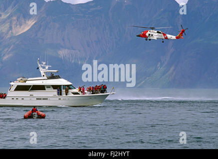 RESCUED PASSENGERS from the YORKTOWN CLIPPER aboard a private vessel with COAST GAURD HELICOPTER assisting - GLACIER BAY, ALASKA Stock Photo