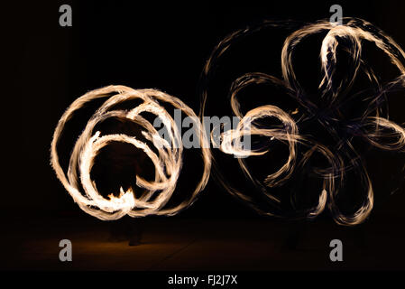 Fire poi in action by a male performance in Thai restaurant Stock Photo