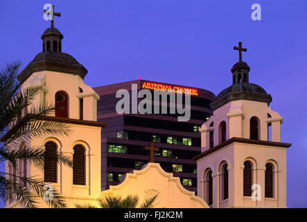 The ARIZONA CENTER is seen through the twin steeples of ST. MARY'S BASILICA in downtown PHOENIX, ARIZONA Stock Photo