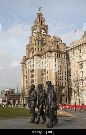 Statue of The Beatles on the Pier Head in Liverpool, with the Royal Liver Building behind. Stock Photo