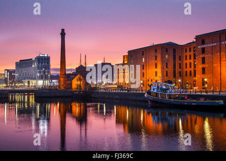 Albert docks in Liverpools dockland; Early Morning at Liverpool, Merseyside, 29th February 2016. UK Weather. Cold, Crisp, Calm, Purple Dawn (Twilight crepuscular rays) a phenomenon which lasts a few minutes, with associated sunrise over the Albert Dock & Pierhead. Albert Dock is a major tourist attraction in the city and the most visited attraction in the United Kingdom, outside London. It is a vital component of Liverpool's UNESCO designated World Heritage Maritime Mercantile City. The docking complex and warehouses also comprise the largest single collection of Grade I listed buildings an Stock Photo