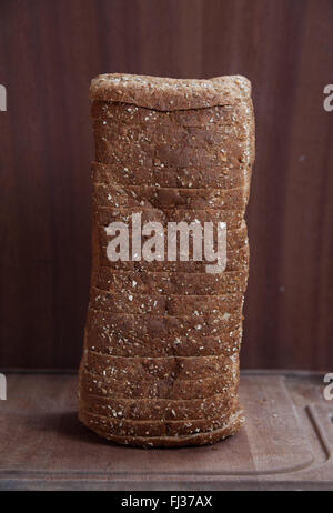 A stack of wholemeal bread on a wooden surface Stock Photo