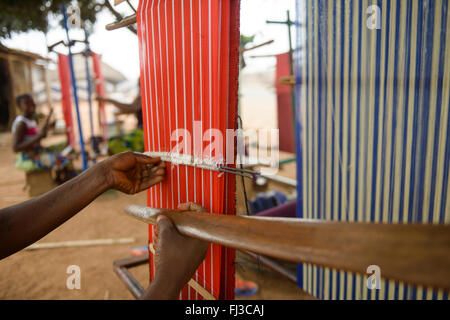 Girls and women working on their looms, Benin, Africa Stock Photo