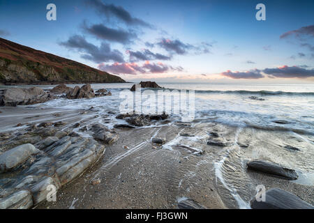 Dusk on the beach at Hemmick near Gorran Haven on the the south coast of Cornwall Stock Photo