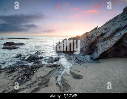 Sunset on the beach at Hemmick on the south coast of Cornwall Stock Photo