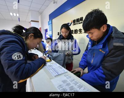 Beijing, China. 29th February, 2016. A student fills an express delivery form at the 'Lou Ti Jian' company established by student-maker Li Xinyue and Li Jian in Taiyuan, north China's Shanxi Province, Dec. 17, 2015. By encouraging mass entrepreneurship and innovation, China saw a record startup boom in 2015 as a total of 4.44 million companies were established, up 21.6 percent from a year ago. More than 80 percent of the new firms were in tertiary industries. Stock Photo