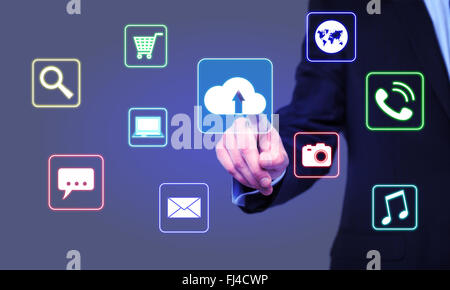 businessman clicks cloud icon on the virtual screen Stock Photo