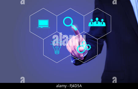 businessman pressing Search button on virtual screens Stock Photo