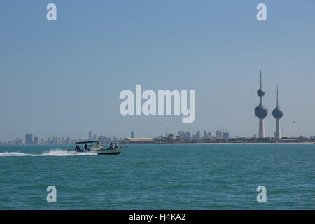 A speed boat passes the Kuwait towers Stock Photo