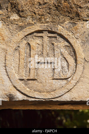 Old IHS sign sculpted above door. Stock Photo