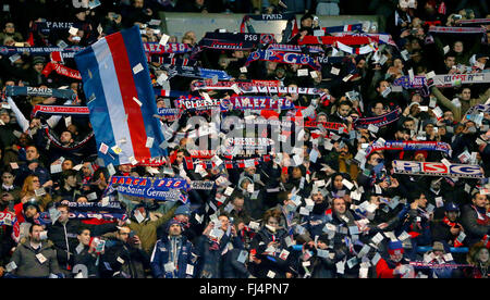 PSG fans singing during the UEFA Champions League round of 16 match between Paris Saint-Germain and Chelsea at the Parc des Princes Stadium in Paris. February 16, 2016. Stock Photo