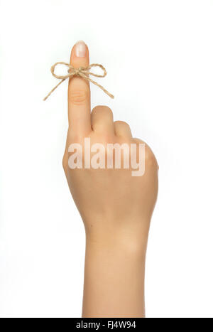 Woman's hand  with reminder string around pointing finger Stock Photo