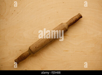 Wooden rolling pin over wood background, above view Stock Photo