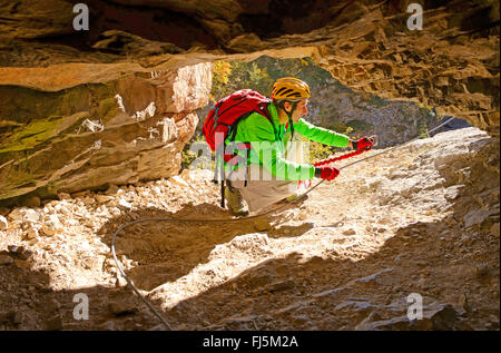 climber in a rock window, via ferrata in the canyon of Etroits, France, Hautes Alpes, Saint Etienne en Devoluy Stock Photo