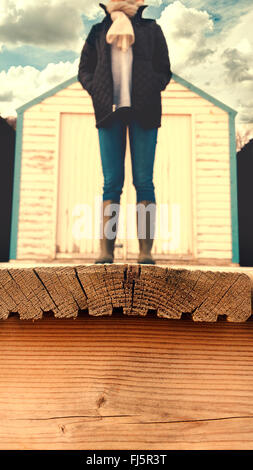 headless woman standing on the wooden floor of the beach cabin Stock Photo