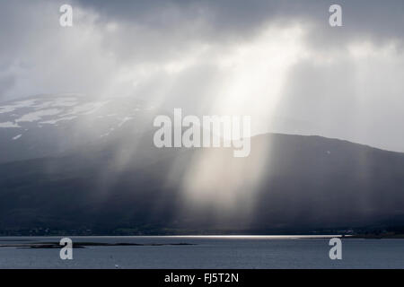 sun rays through hole in clouds, Norway, Troms Stock Photo