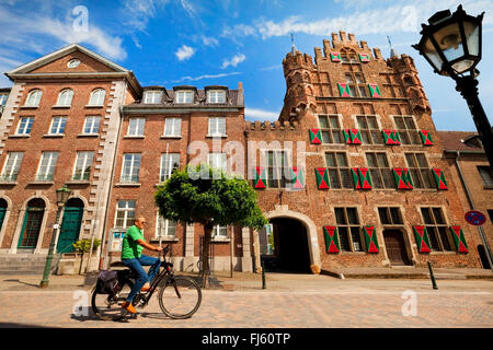 cyclist in front of town hall, and patrician house 'Haus zu den fuenf Ringen', Germany, North Rhine-Westphalia, Lower Rhine, Goch Stock Photo