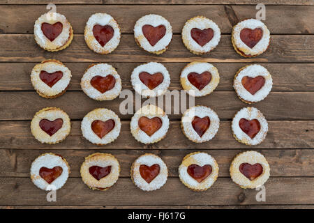 Jam sandwich biscuits (Linzer biscuits). Heart shaped jam biscuits. Stock Photo