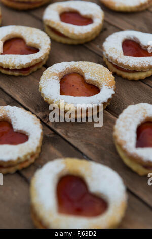 Jam sandwich biscuits (Linzer biscuits). Heart shaped jam biscuits. Stock Photo