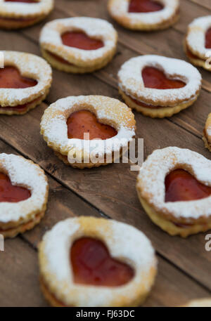 Jam sandwich biscuits (Linzer biscuits). Heart shaped jam biscuits. Stock Photo