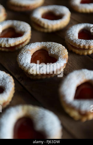 Jam sandwich biscuits (Linzer biscuits). Heart shaped jam biscuits. Stock Photo