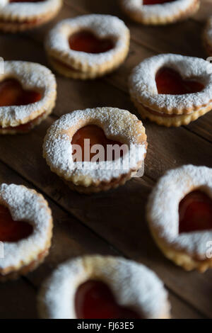 Jam sandwich biscuits (Linzer biscuits). Heart shaped jam biscuits. Stock Photo