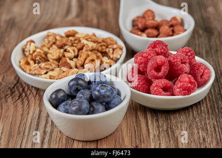 Super food in white china dishes on a wooden table Stock Photo