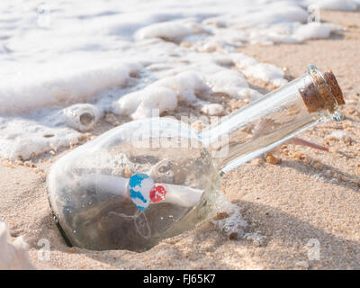 message in the bottle, notification icon alert, the selective focus on the message in the bottle with the sea and bubble wave Stock Photo